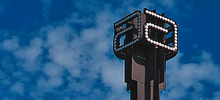 The Abbott Tower at the global headquarters in Abbott Park, Illinois against a light blue sky.